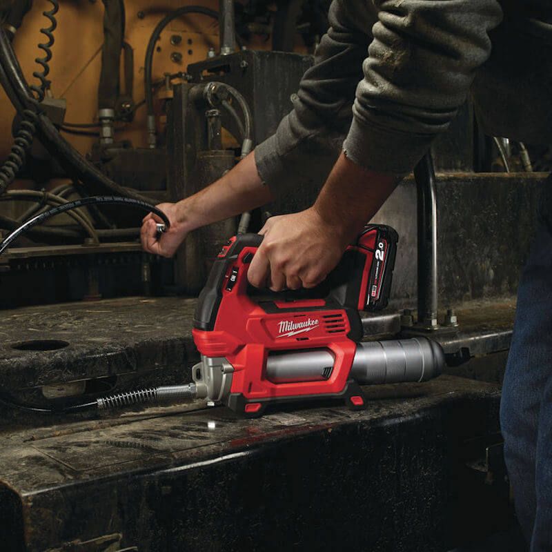 Person using Milwaukee M18 grease gun