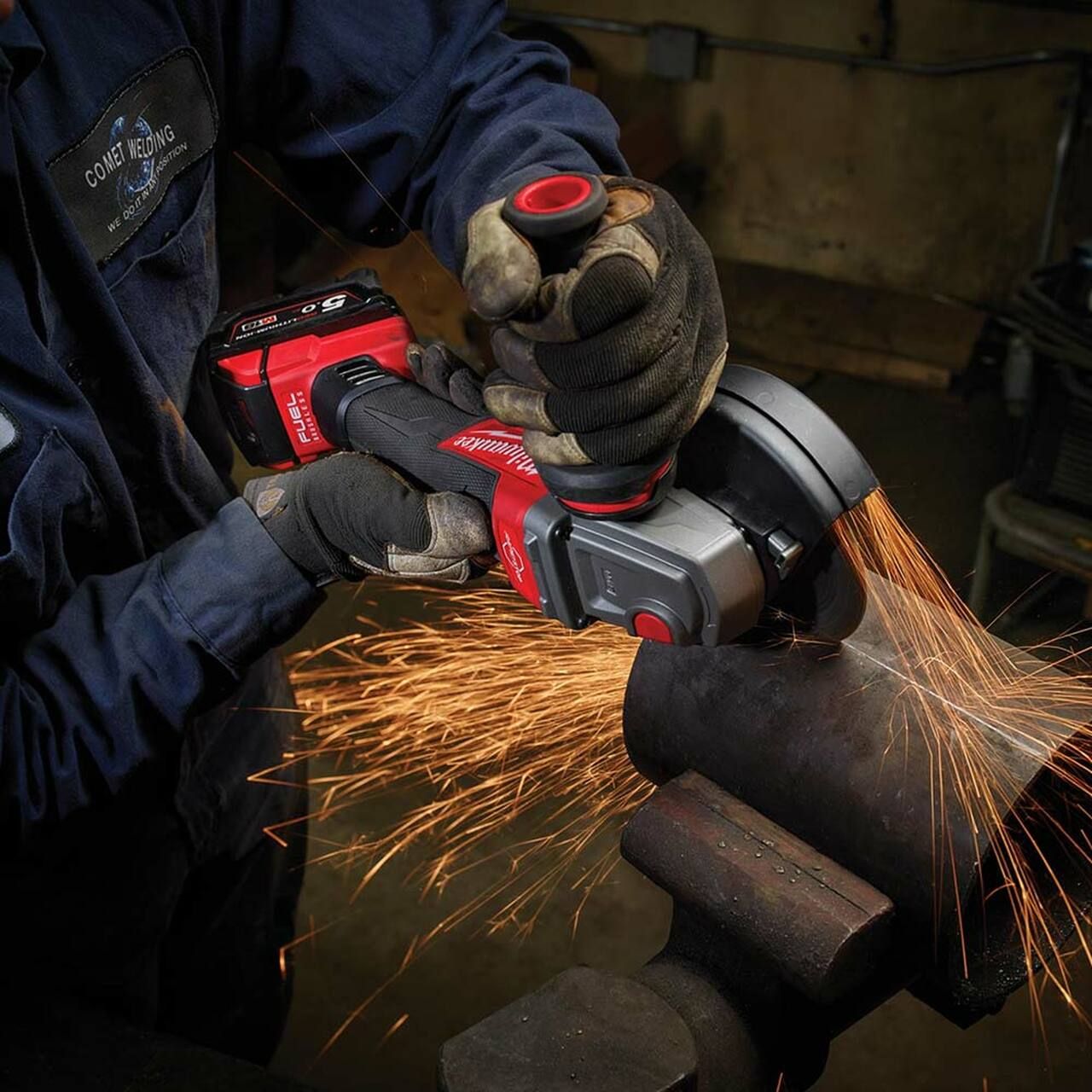 Worker using the MILWAUKEE® M18 FUEL™ 115mm Variable Speed & Braking Angle Grinder to grind metal, highlighting its cordless operation, RAPIDSTOP™ braking system, and ergonomic design for precision and safety on the jobsite.